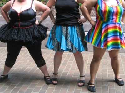 Photos of three heavy-set girls from neck down, arms akimbo, wearing bright skirts and dresses